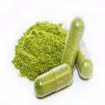 a pile of green powder and pills