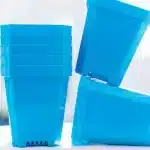 a stack of blue plastic containers