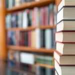 A Stack Of Books In A Library