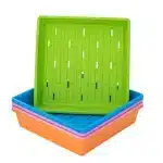 Stack of 1010 color trays with holes with green on top