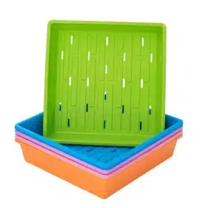 Stack of 1010 color trays with holes with green on top