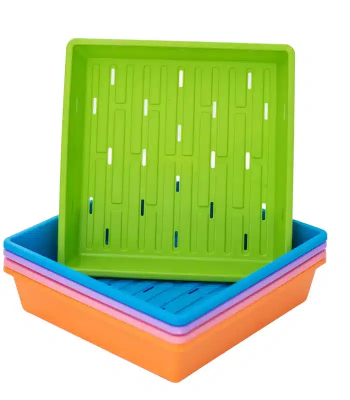 Stack of 1010 color trays with holes with green on top