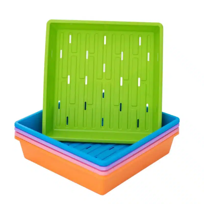 Stack Of 1010 Color Trays With Holes With Green On Top